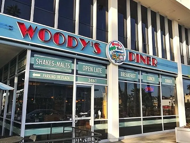 Charming diner with retro signage offering shakes, malts, and classic meals, open late for breakfast, lunch, and dinner.