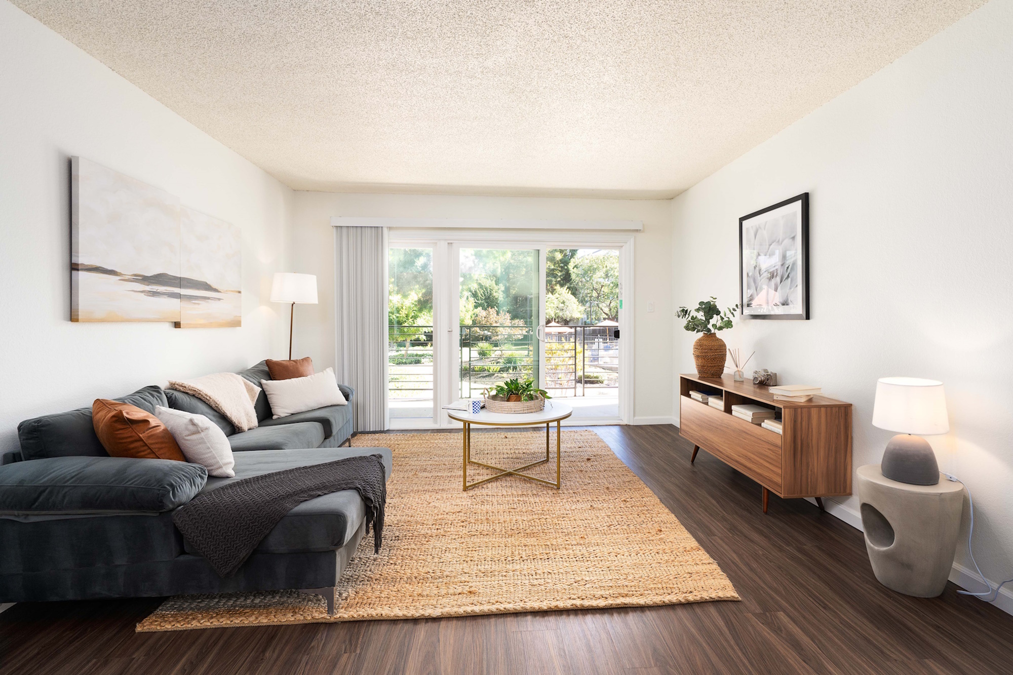 Bright and airy living room with modern decor and large window view.