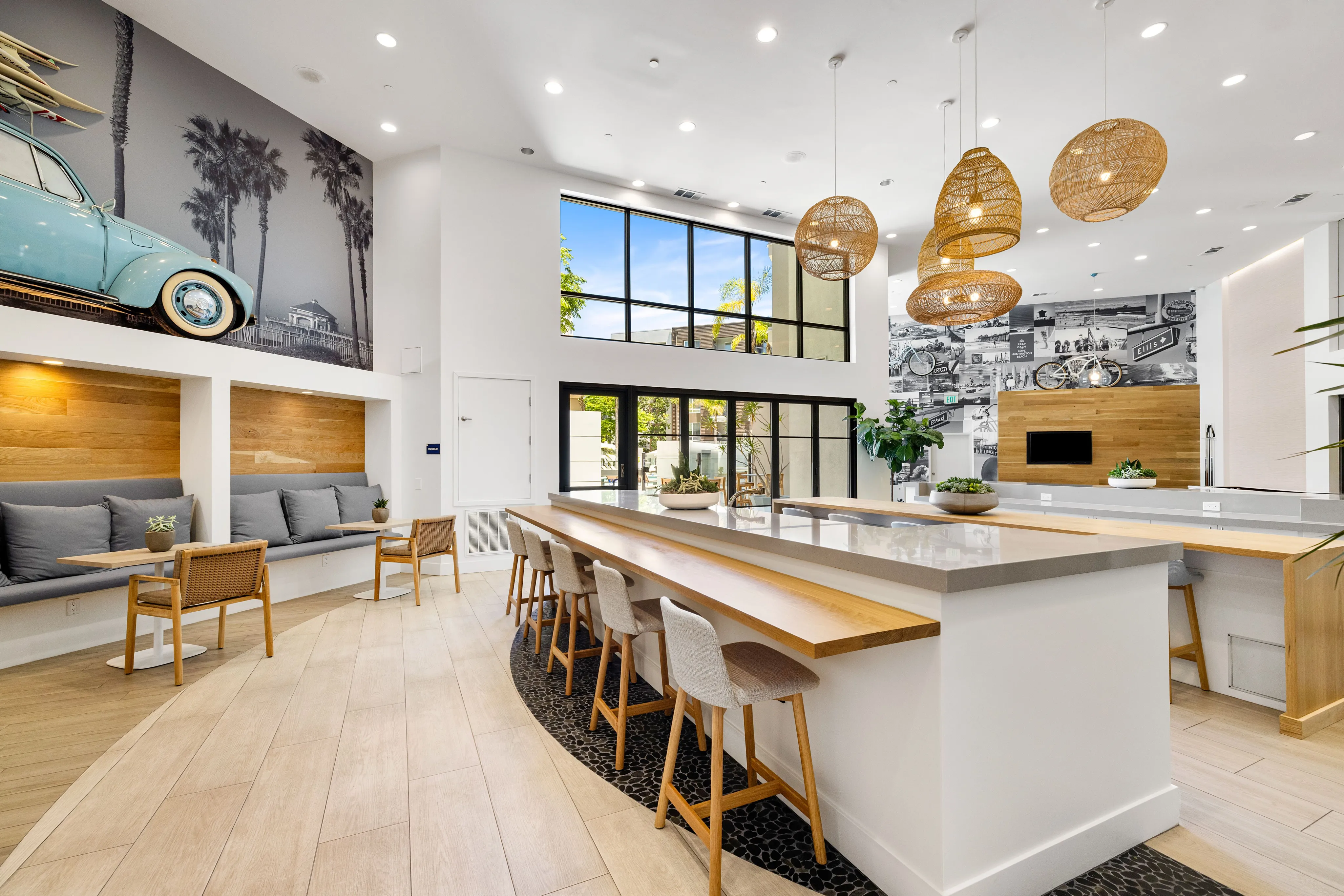 Resident club room with lounge seating, catering kitchen for resident events, dining table, pool table, multiple seating and TV viewing areas