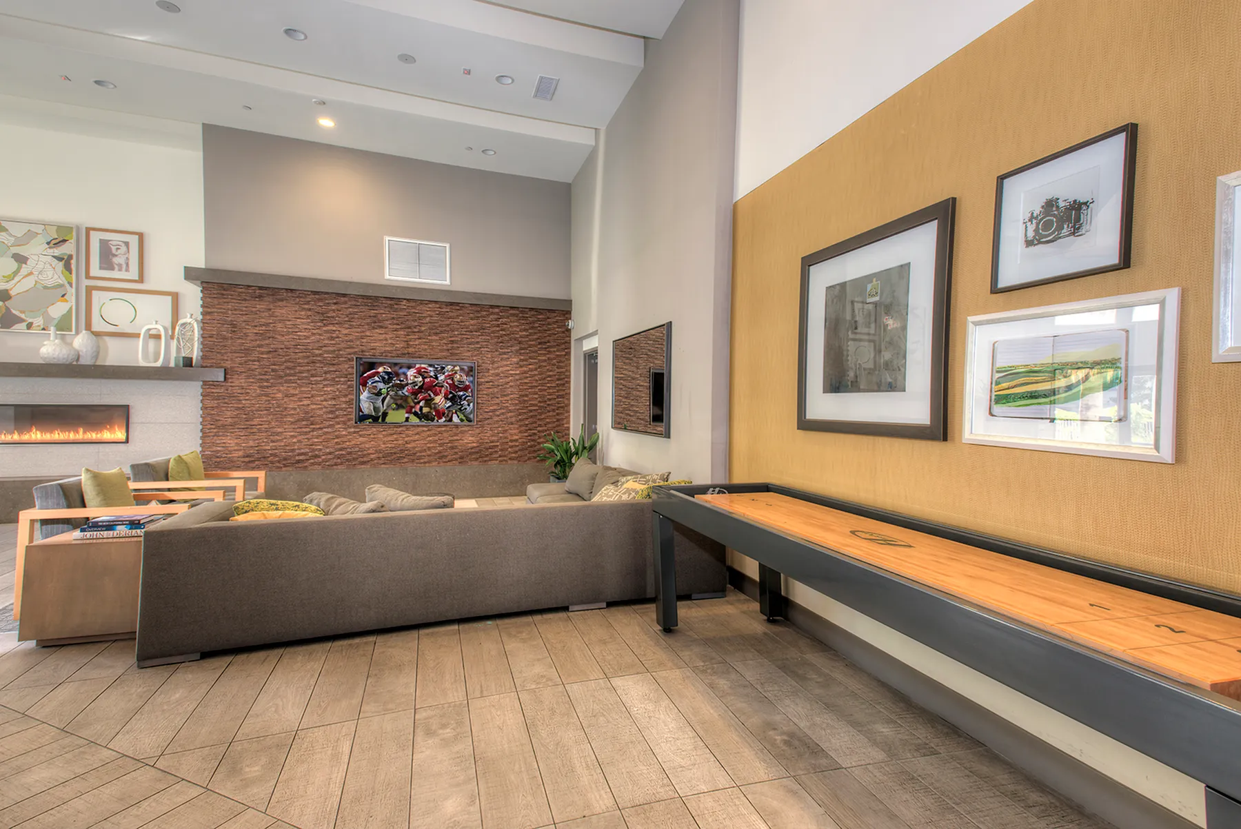 Modern and inviting living room with cozy seating, vibrant artwork, and sleek fireplace, creating a perfect space for relaxation or entertainment.