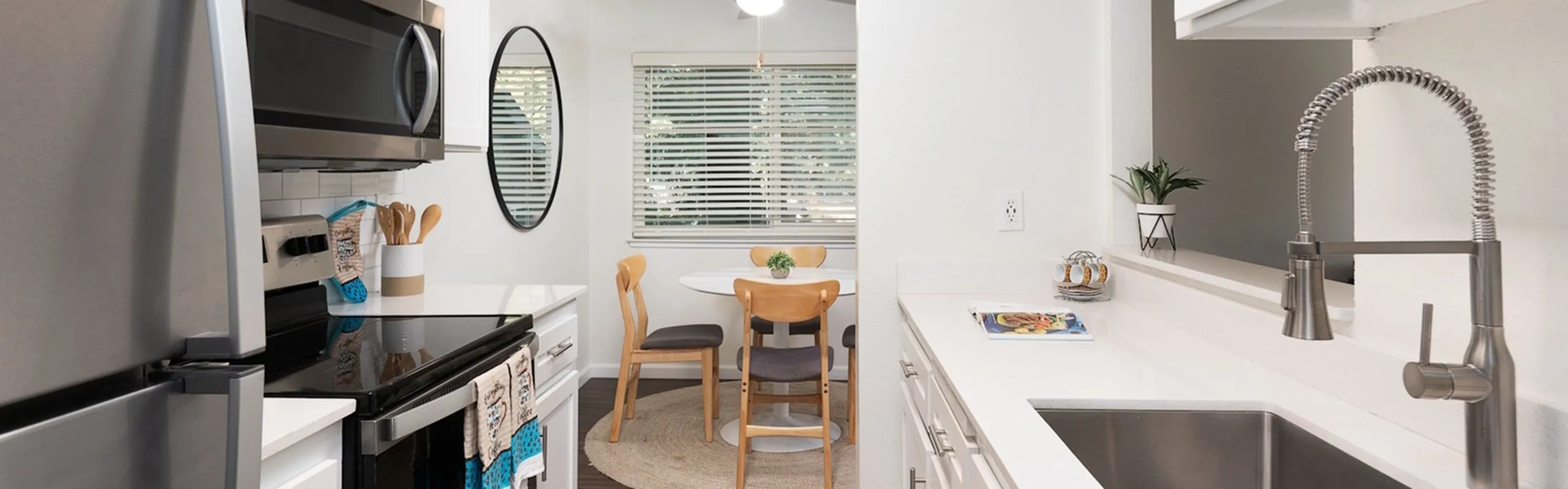 Bright and stylish kitchen with stainless steel appliances and cozy dining area