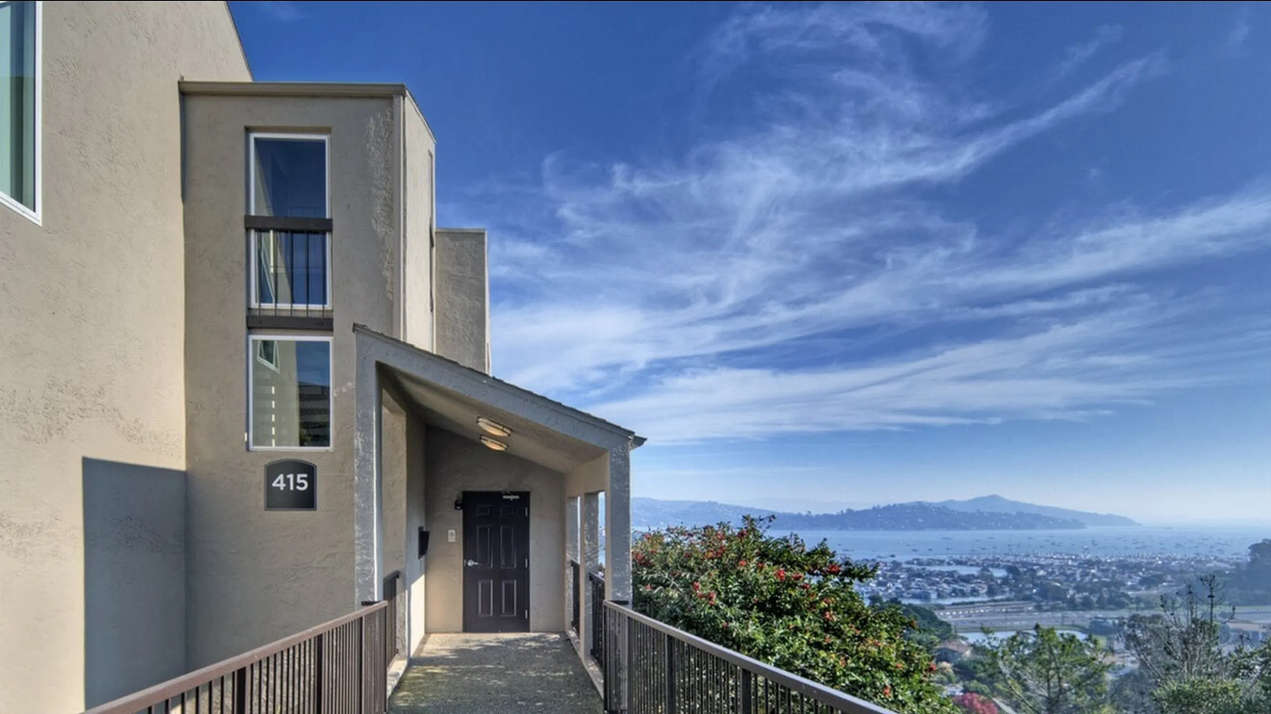 Elegant apartment entrance with stunning views and modern architecture.