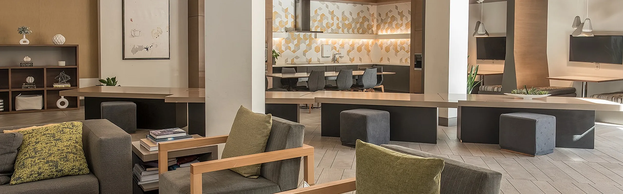 Modern open-concept lounge with sleek furniture, cozy seating area, and stylish decorative elements, perfect for relaxing and socializing.