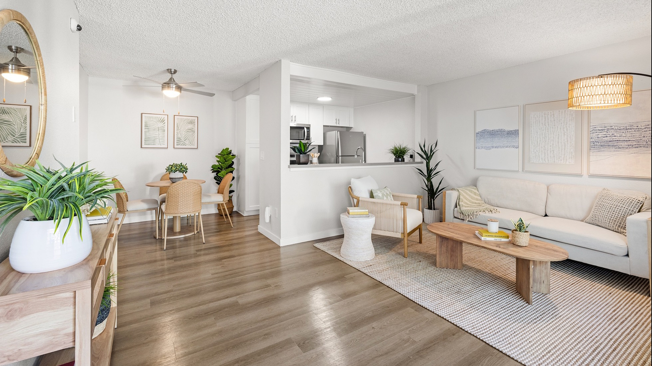 Modern open-concept living and dining area with stylish decor, cozy seating, and abundant natural light.