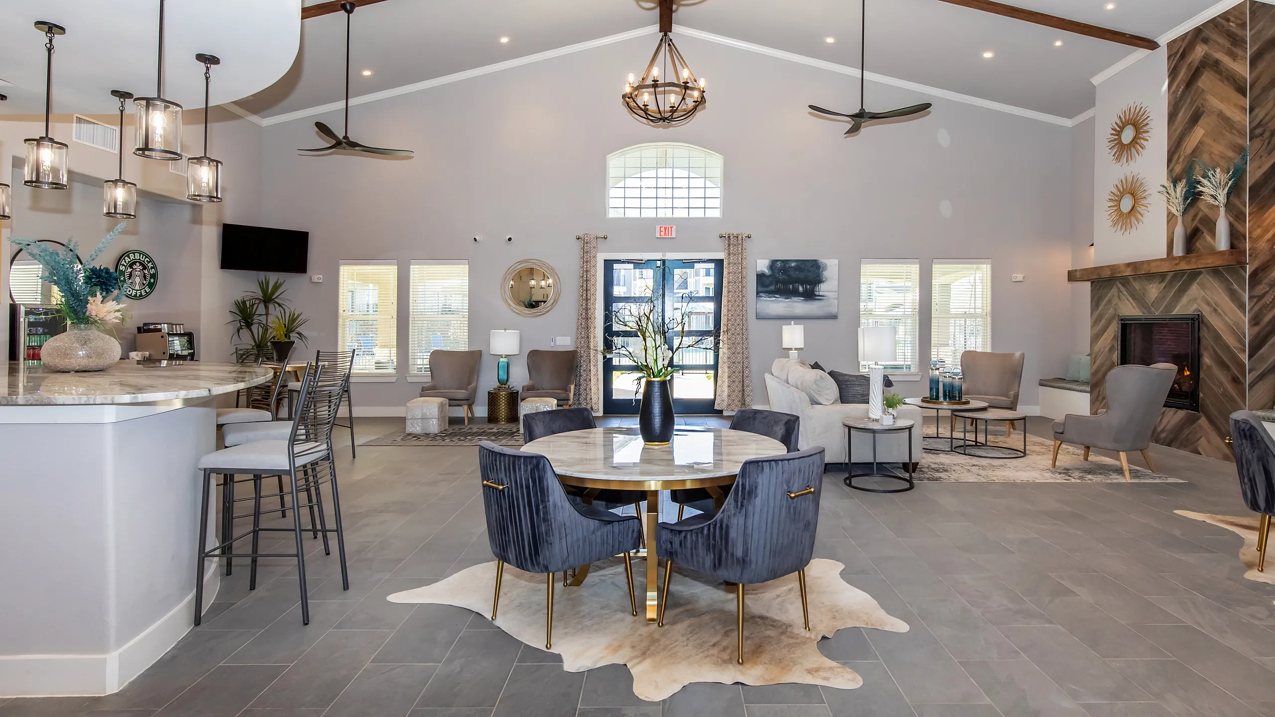 Luxurious community lounge featuring modern decor, stylish seating, and a contemporary fireplace.