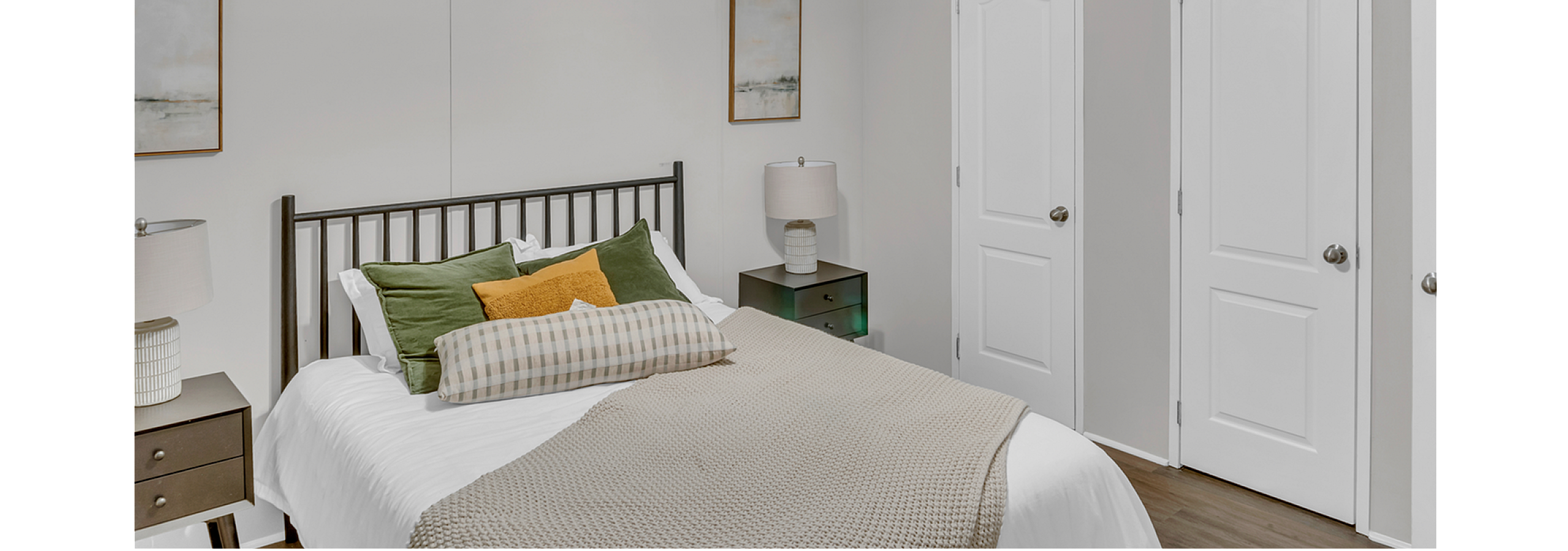 Cozy bedroom with modern ceiling fan, elegant bedside tables, and plush bedding in soothing earth tones.