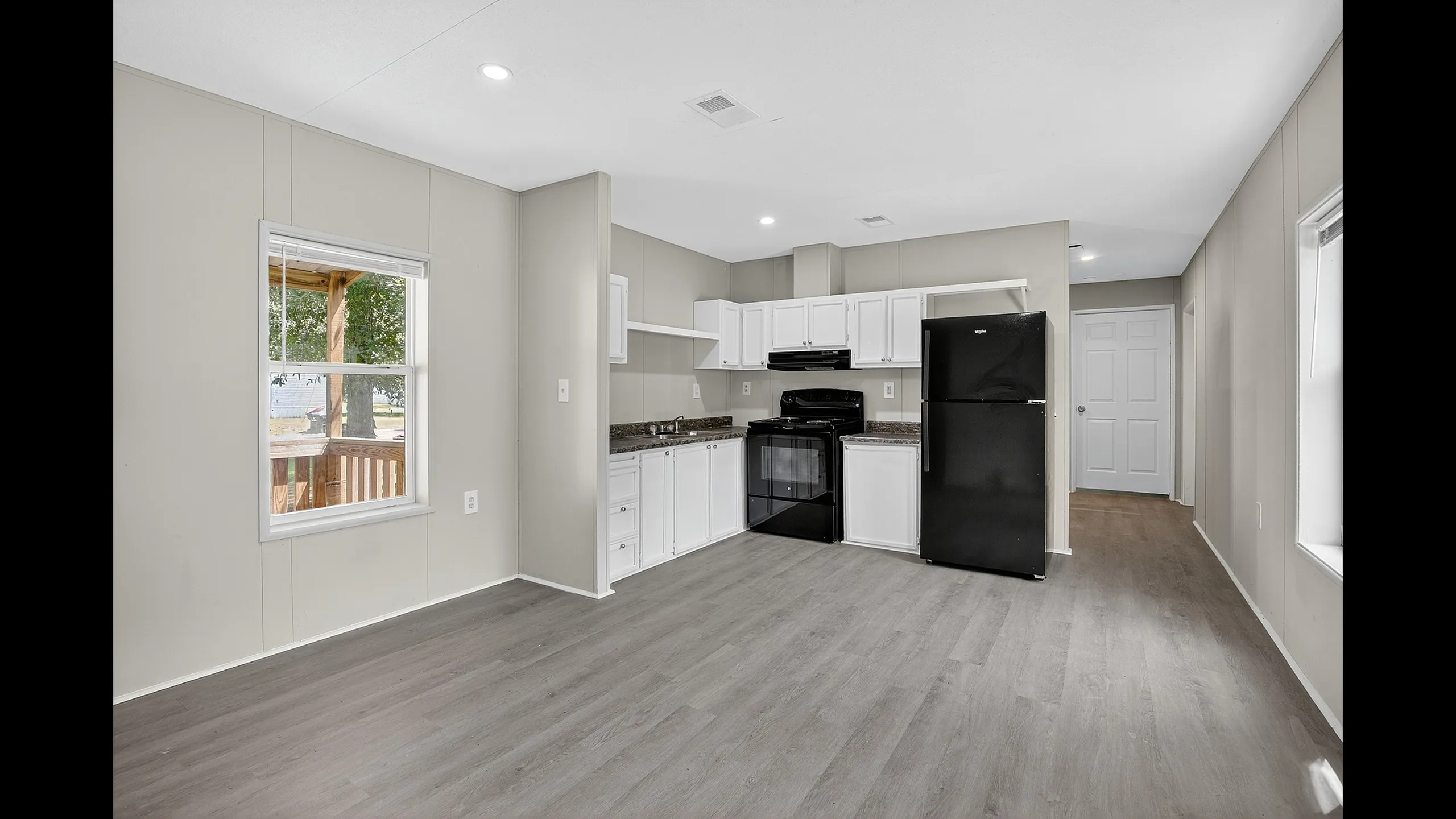 Modern kitchen with sleek white cabinetry, elegant countertops, and a spacious open layout, perfect for entertaining.