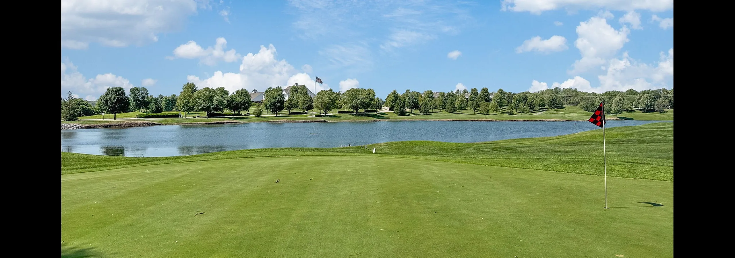Exquisite golf course view with lush green fairways overlooking a serene lake and picturesque landscape, perfect for relaxation and leisure.