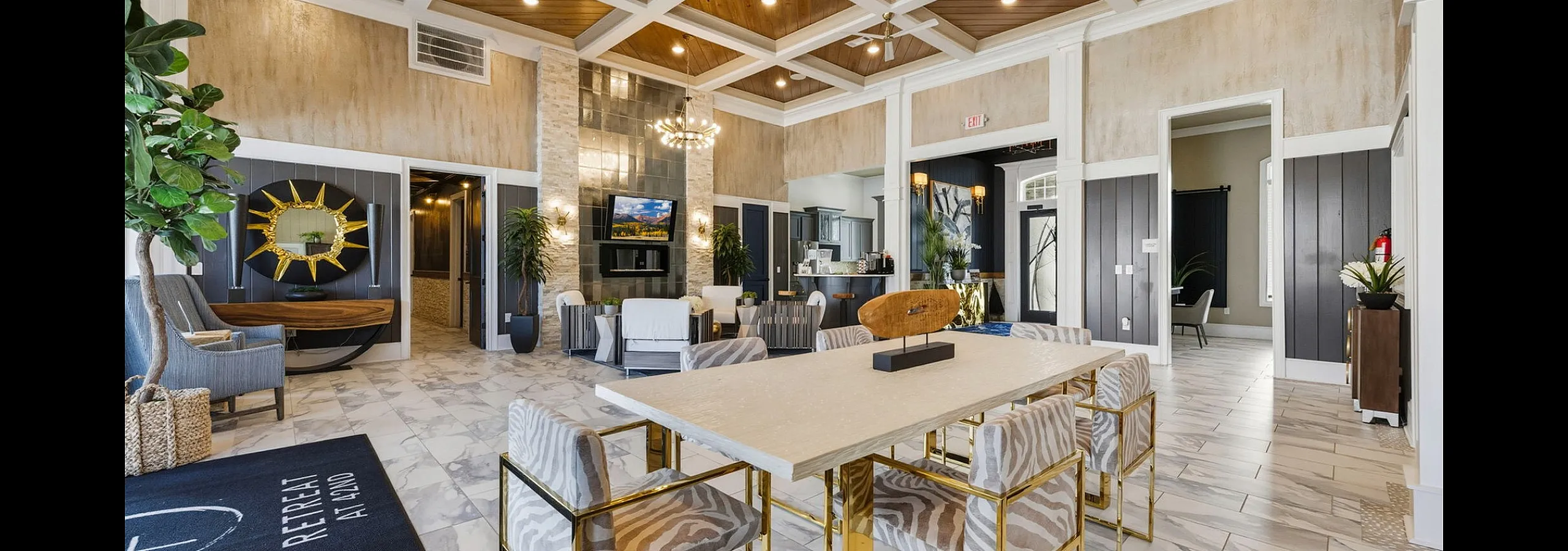 Luxurious lobby with high ceilings, elegant chandelier, and modern seating in a stylish apartment complex.