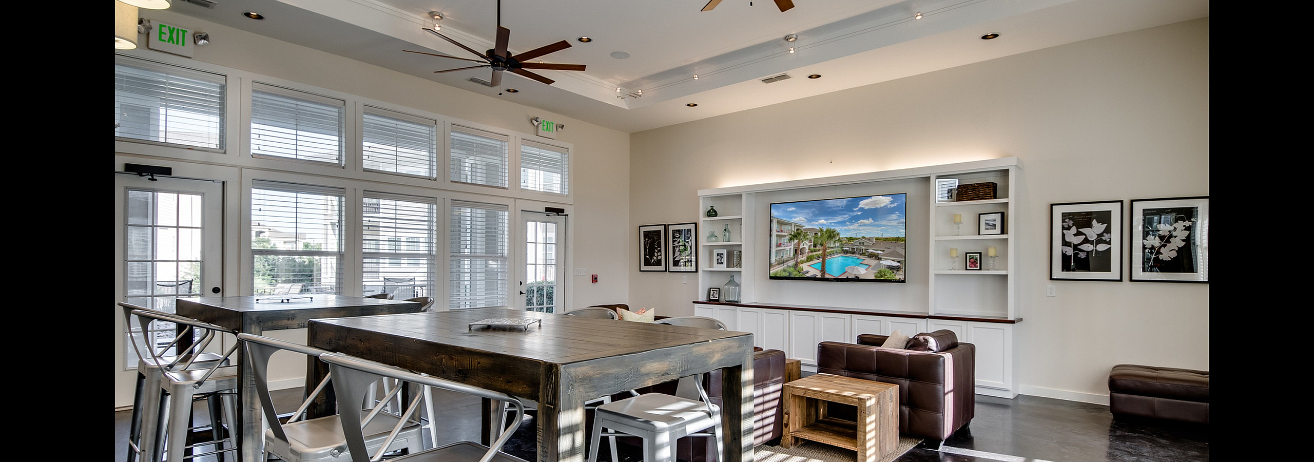 Beautifully designed modern lounge area with high ceilings, elegant wooden tables, and plush seating, ideal for relaxation and social gatherings.