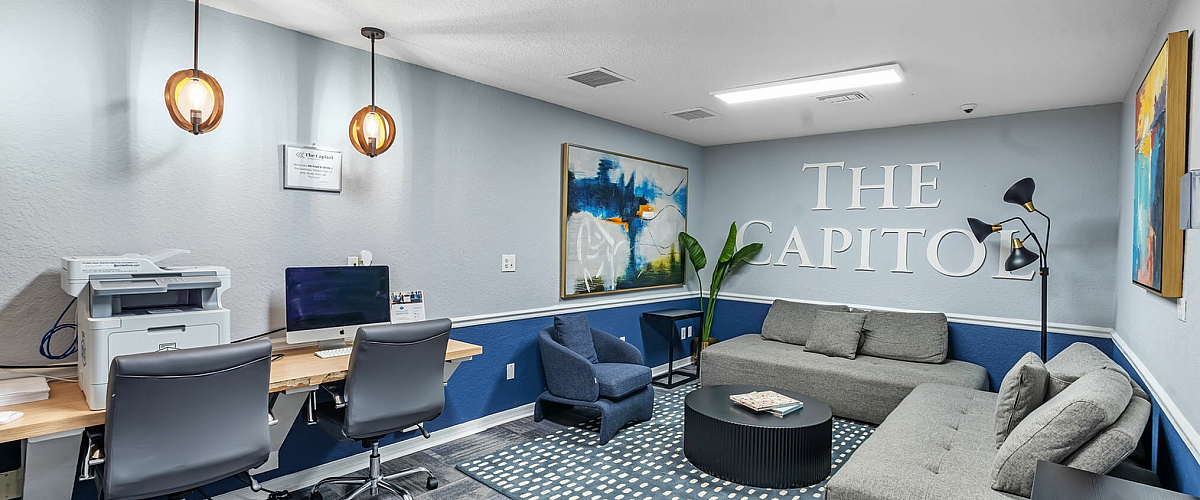 Elegant office space showcasing modern design with sleek furniture, stylish lighting, and vibrant artwork, perfect for productivity.