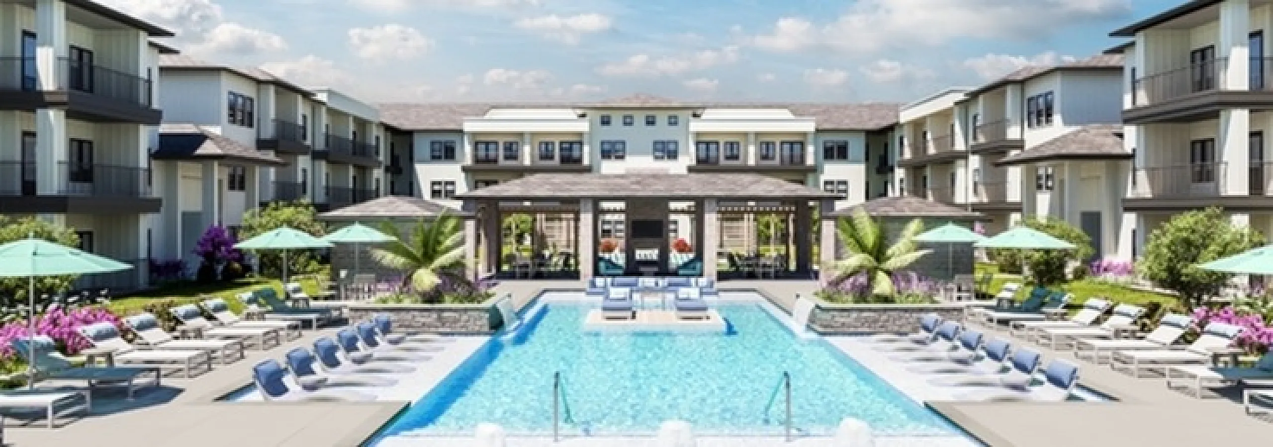 Luxurious apartment complex with a sparkling swimming pool, elegant lounge chairs, and modern architecture under a bright, blue sky.