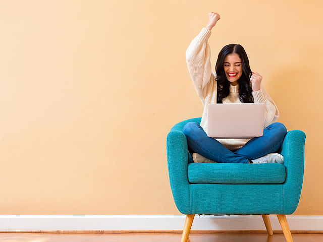 person in chair with laptop
