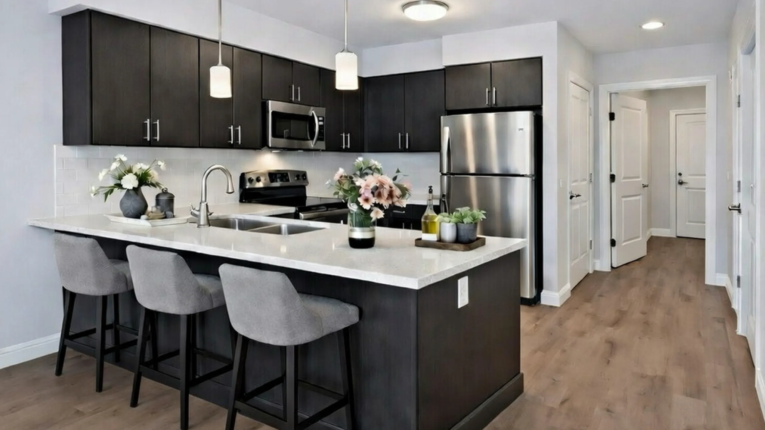 Kitchen with dark cabinets and stainless appliances