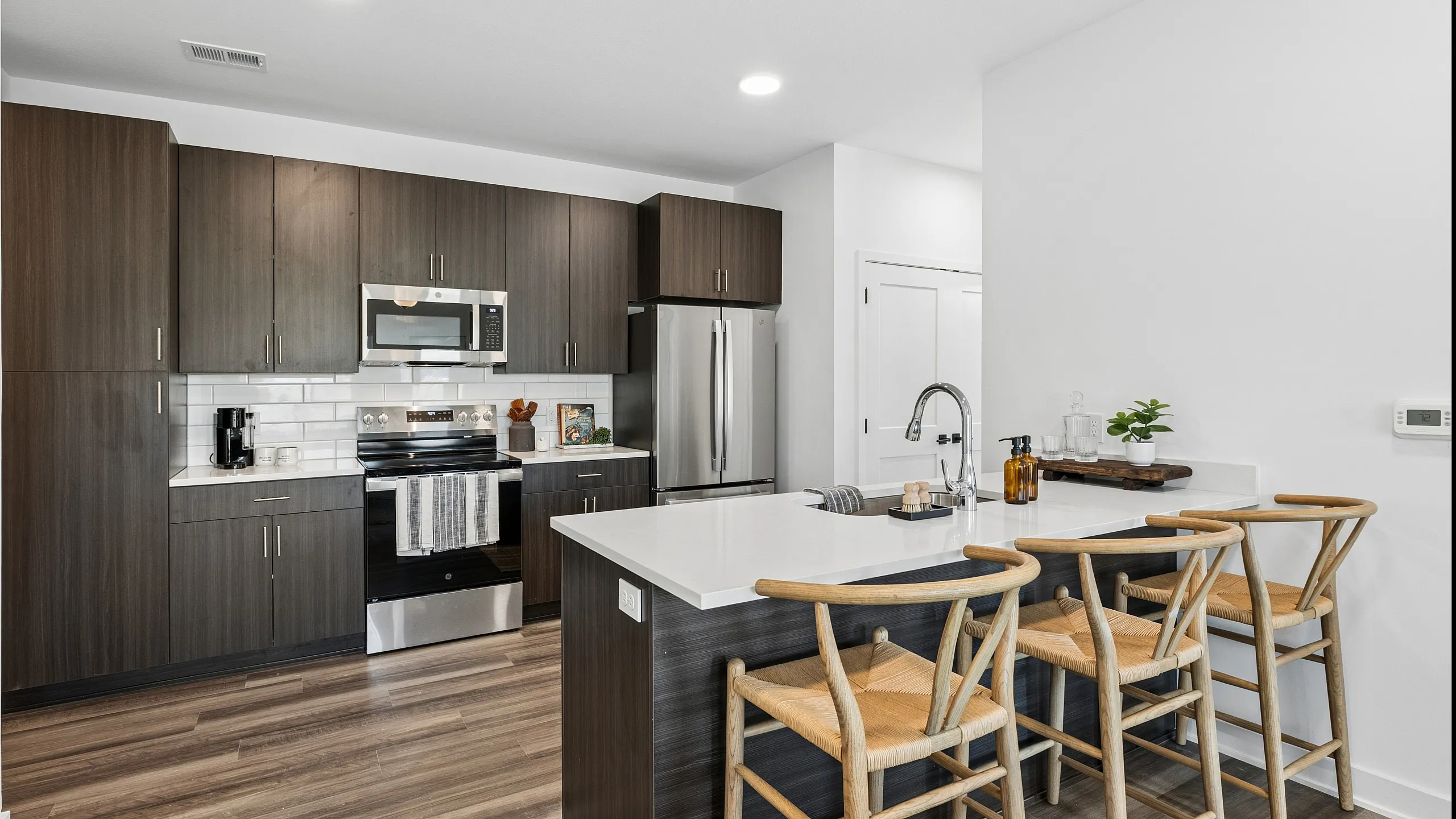 Kitchen with dark cabinets and stainless appliances