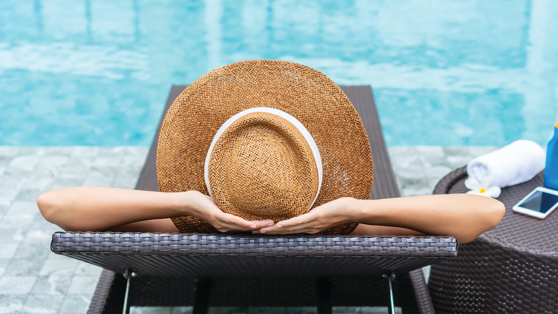 Woman on a pool lounge chair