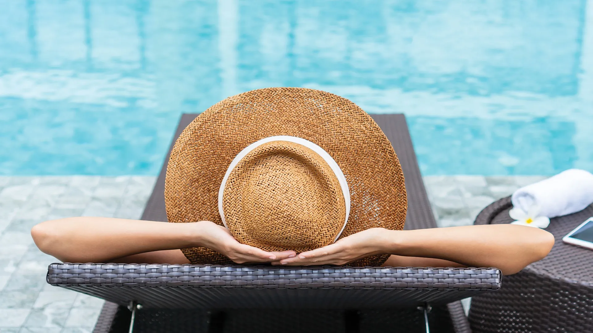 Woman lounging by the pool
