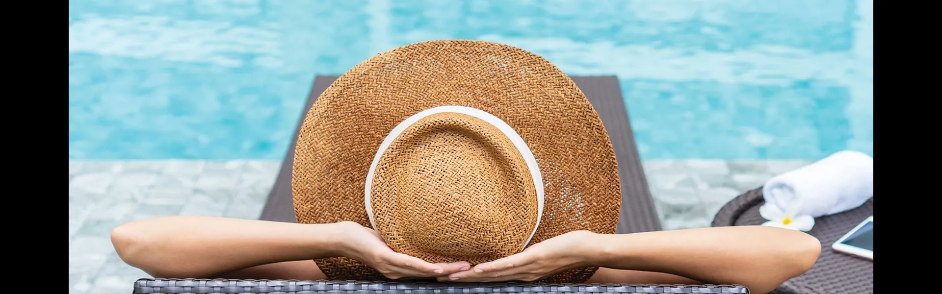Photo of a woman lounging by the pool