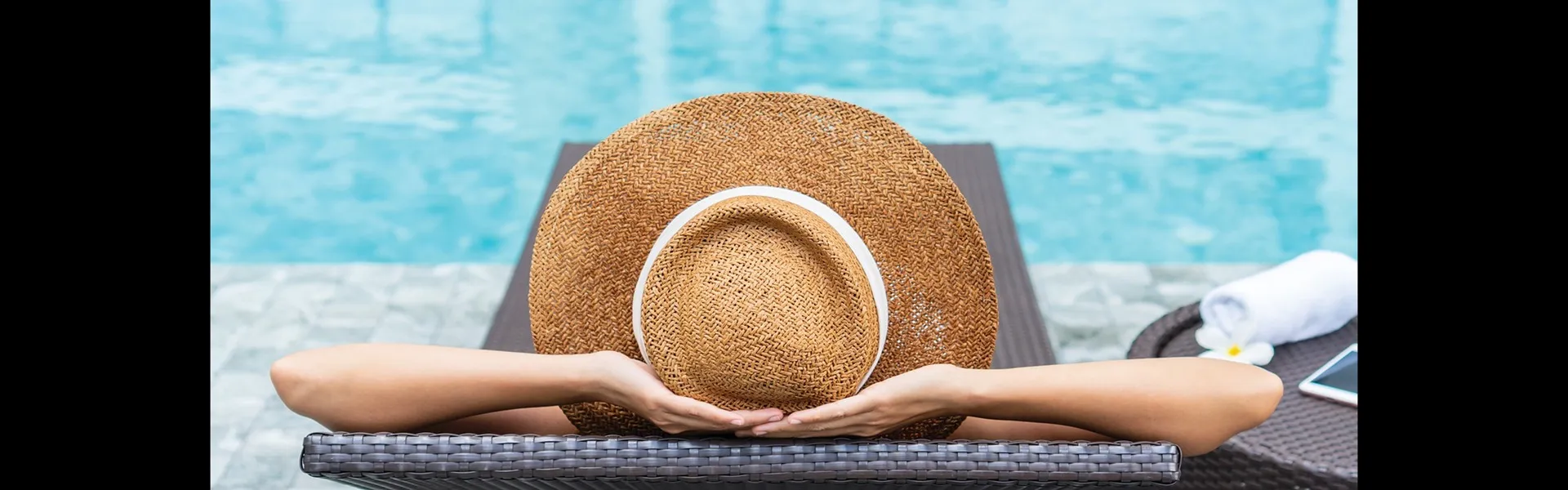 Photo of a woman lounging by the pool