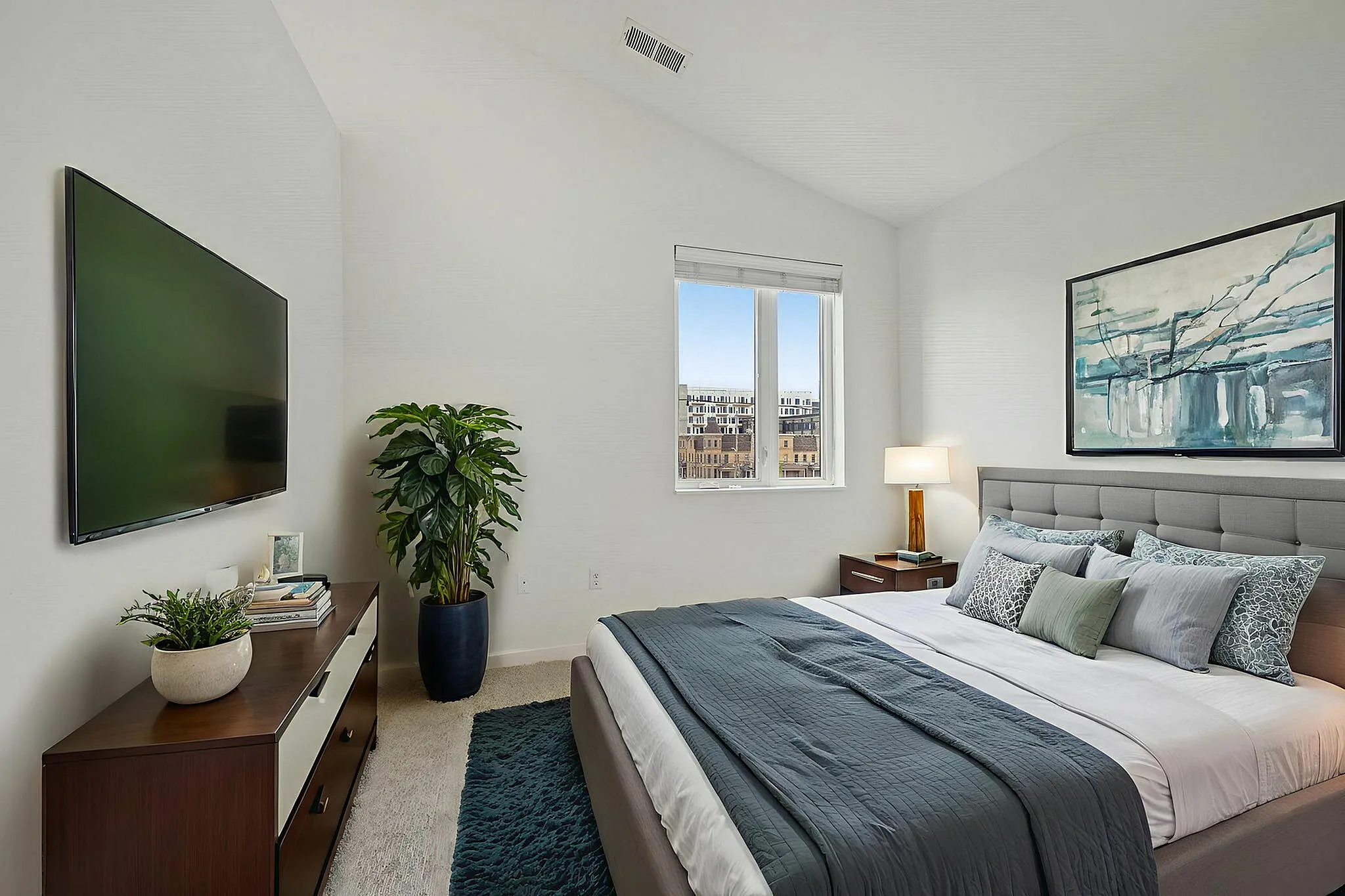 Elegant bedroom with vaulted ceilings and plenty of natural sunlight!