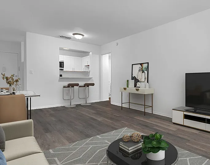 Modern open-concept living space with sleek hardwood flooring, stylish bar stools, and contemporary decor, featuring a cozy seating area and a spacious kitchen.