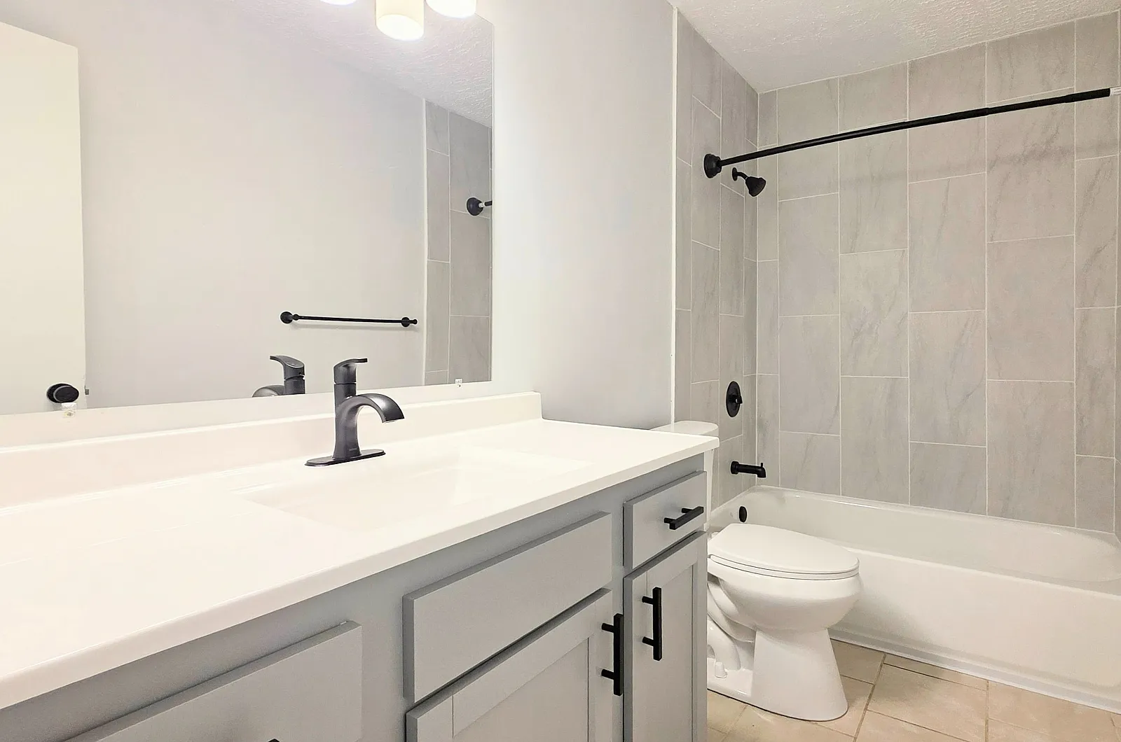 Modern bathroom featuring sleek fixtures, elegant tilework, and a stylish vanity for a luxurious feel.