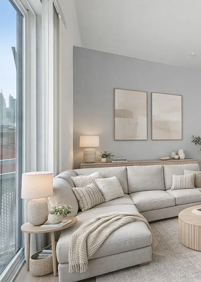 Elegant open-concept living space featuring a cozy sectional sofa, stylish dining area, and modern kitchen with sleek appliances.