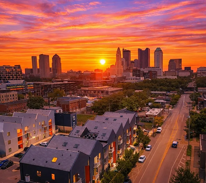Vibrant cityscape at sunset with modern apartments and a stunning skyline backdrop, offering dynamic urban living.