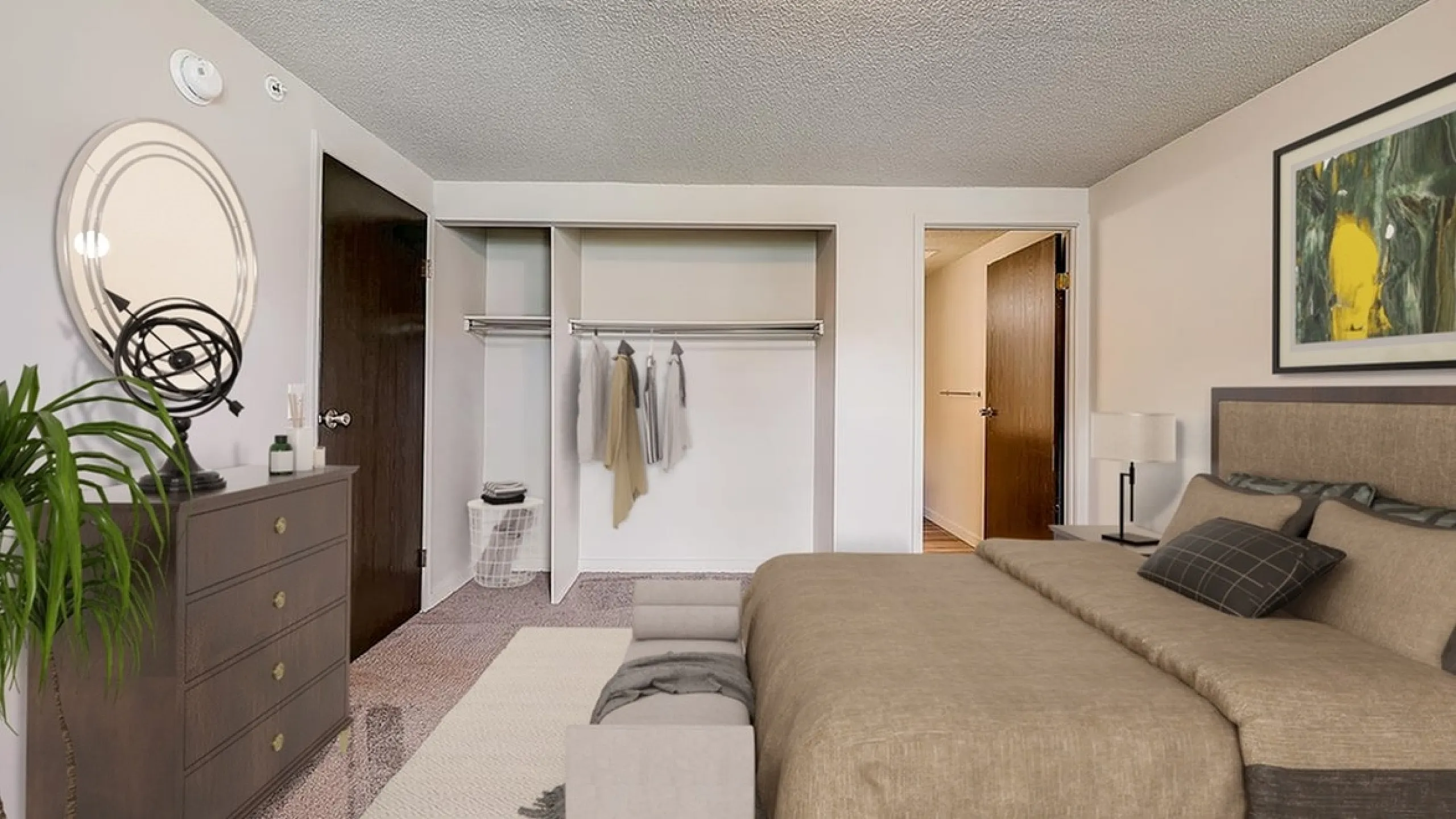 Elegant bedroom with spacious open closet, cozy bed setup, and stylish decor including a framed artwork and a sleek dresser.
