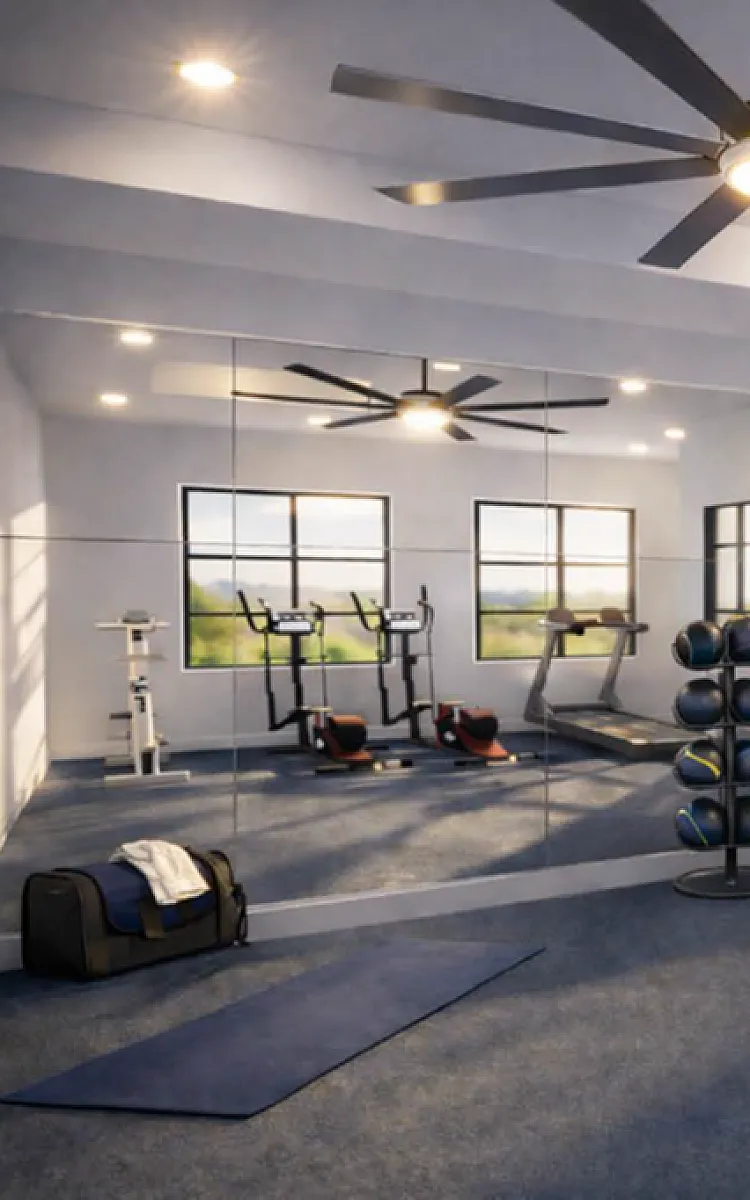 Modern fitness center in residential complex equipped with treadmills, weightlifting benches, and large mirrors enhancing the space.