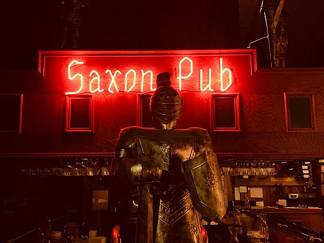 exterior shot of Pubs Neon sign