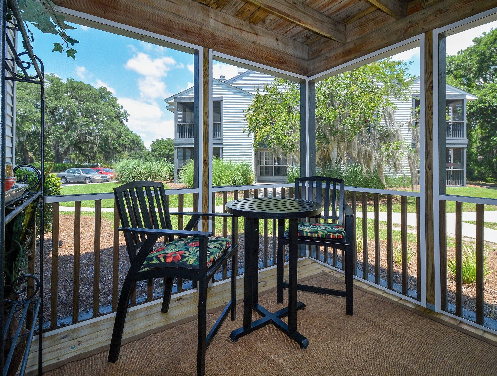 Screened in porch with table and chairs