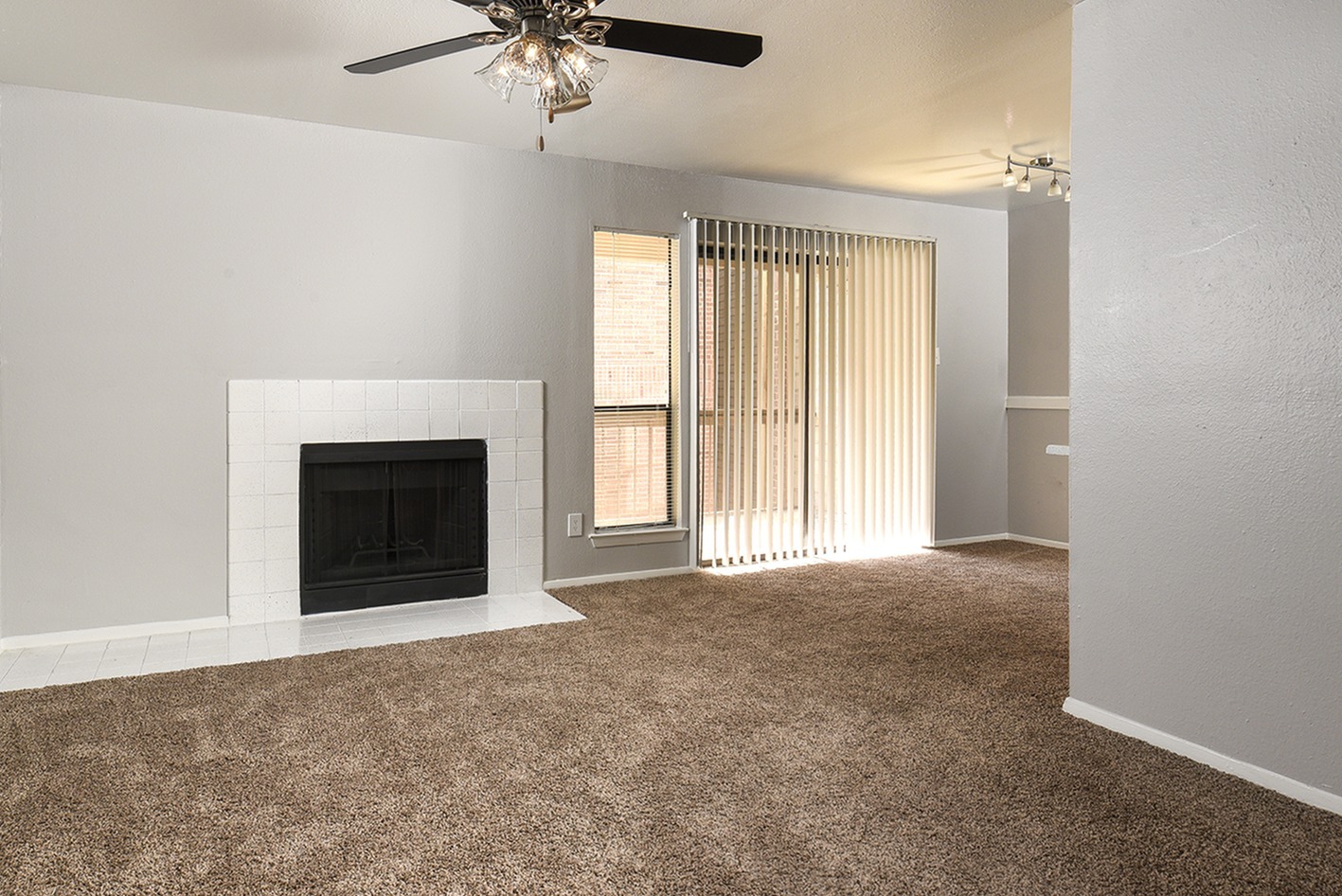 Fireplace | white tile | carpet | sliding glass door