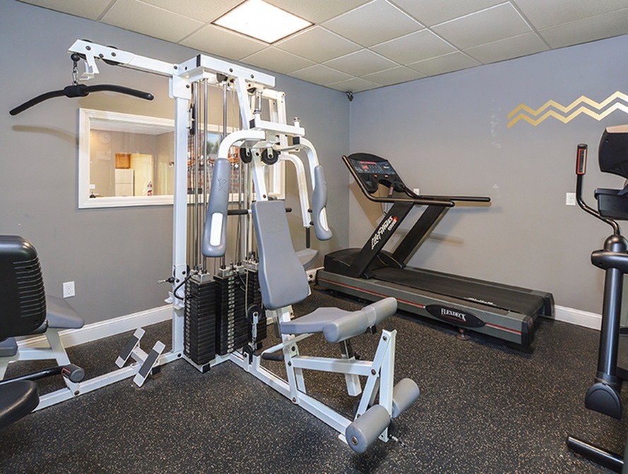Fitness Center with weight machine, treadmill and elliptical.