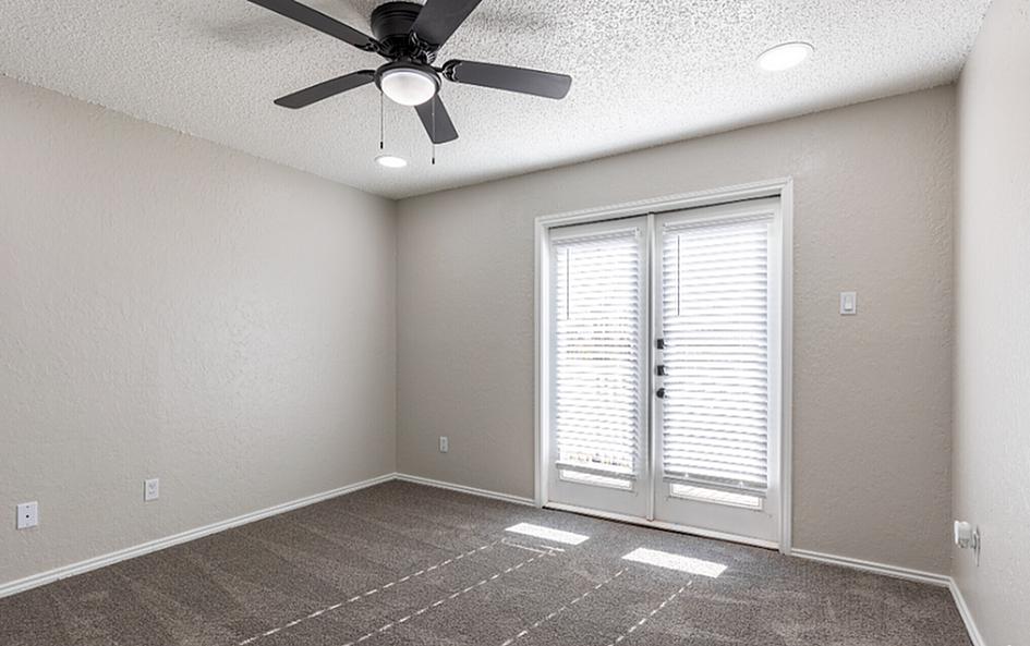 Cozy and bright bedroom French Doorsan, and French doors leading to natural light.