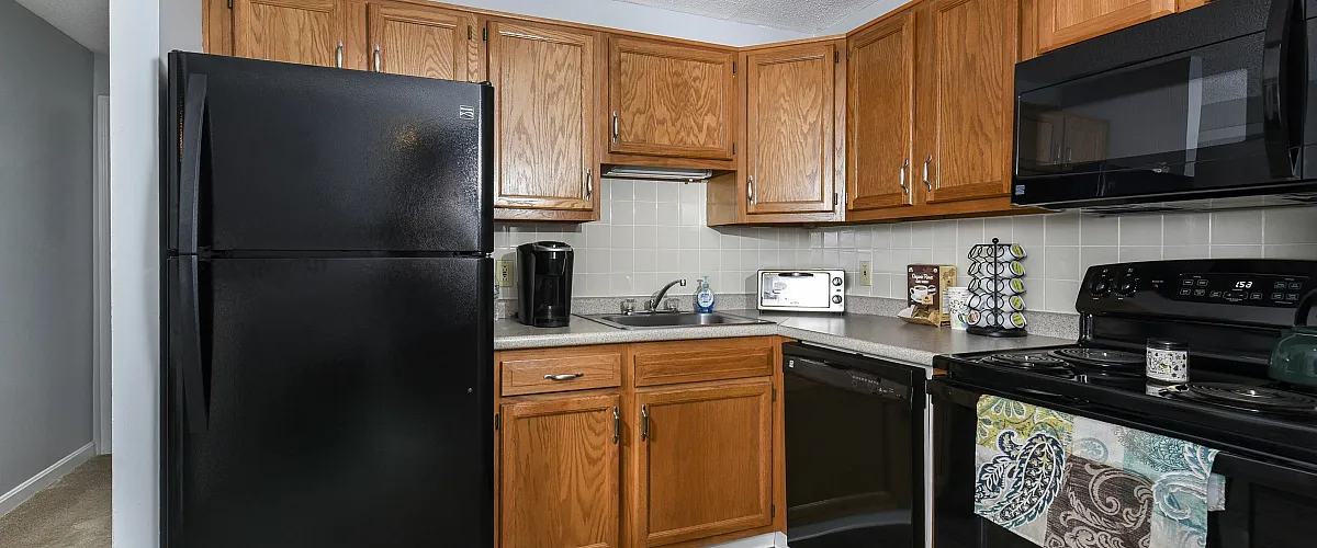 Kitchen with oak cabinets and black appliances