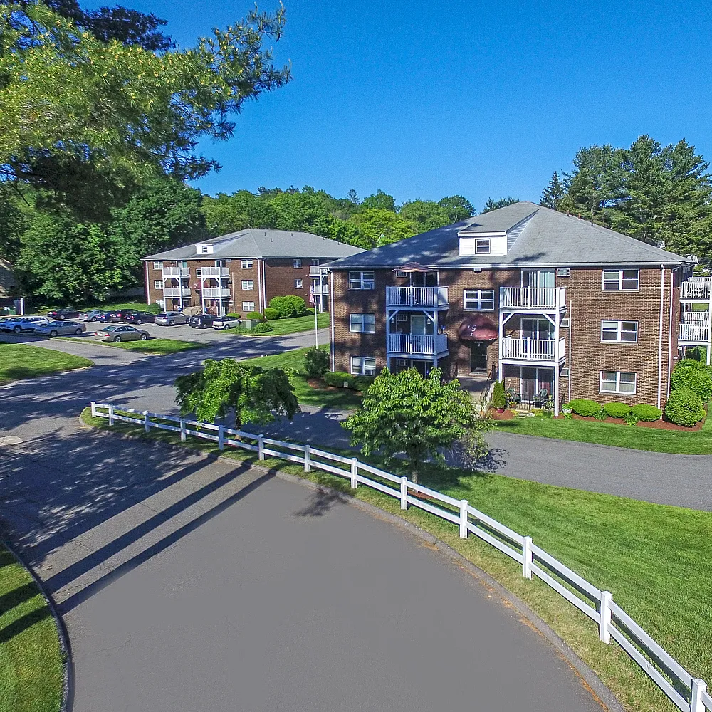 Exterior of buildings as you drive up to the property | white fence