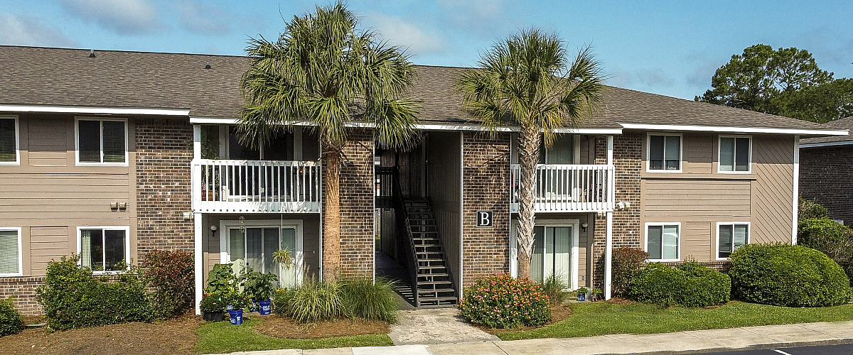 Exterior of building with patio and balconies