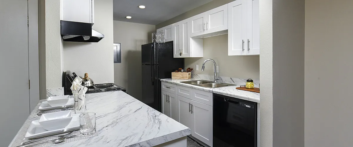 Kitchen | plank flooring | White cabinets and black appliances
