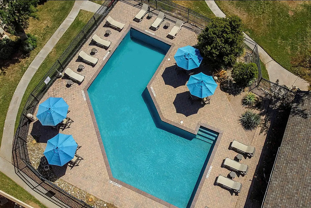 Aerial View of pool with 4 blue umbrellas