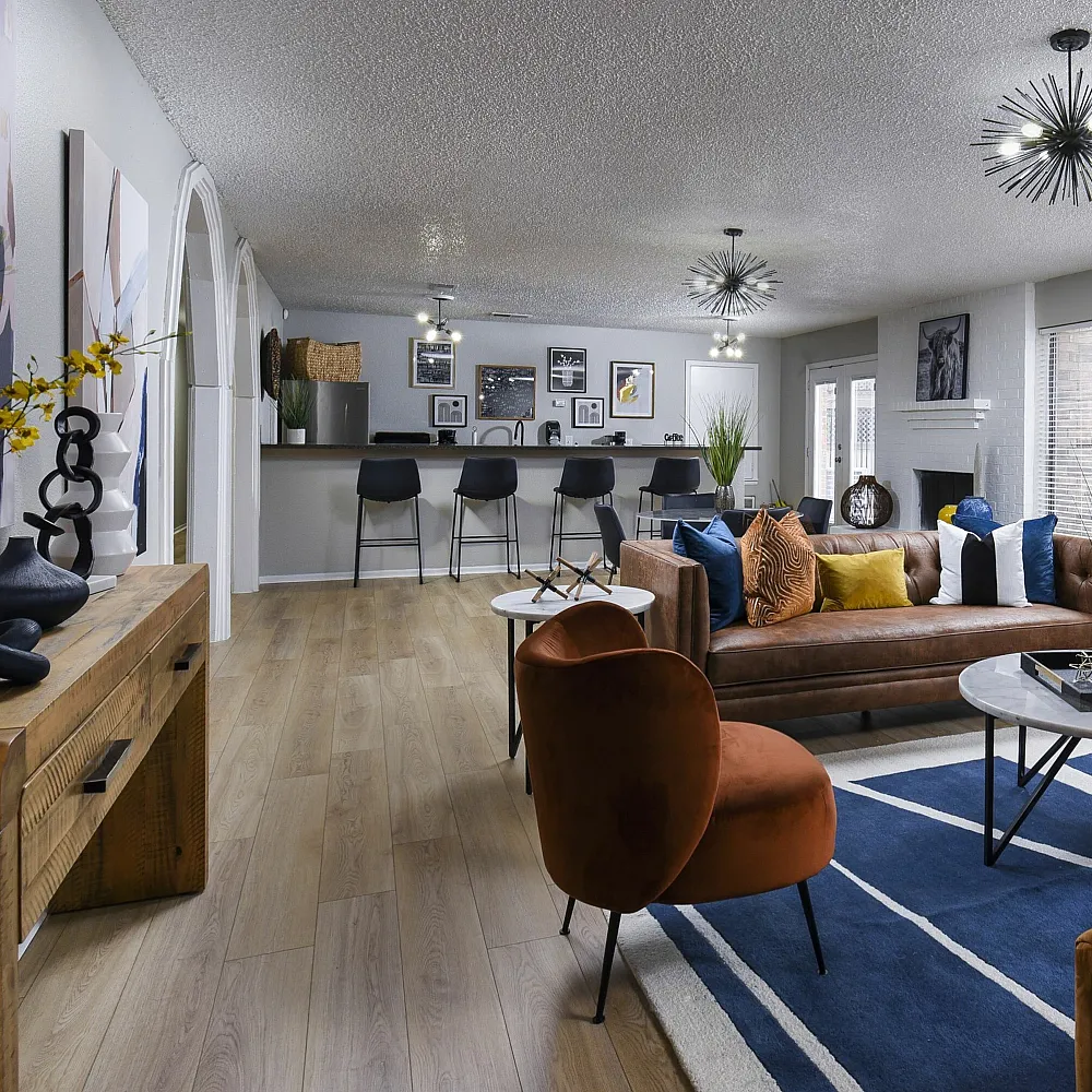 Modern open-concept leasing area with cozy seating, sleek bar area, and vibrant decor.