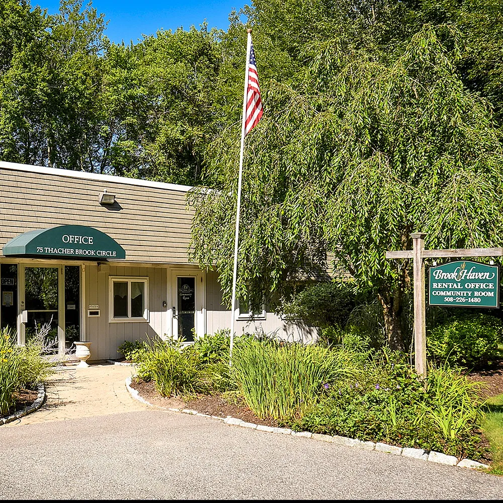 Charming rental office nestled among lush greenery at Brook Haven, complete with easy access and welcoming pathways.