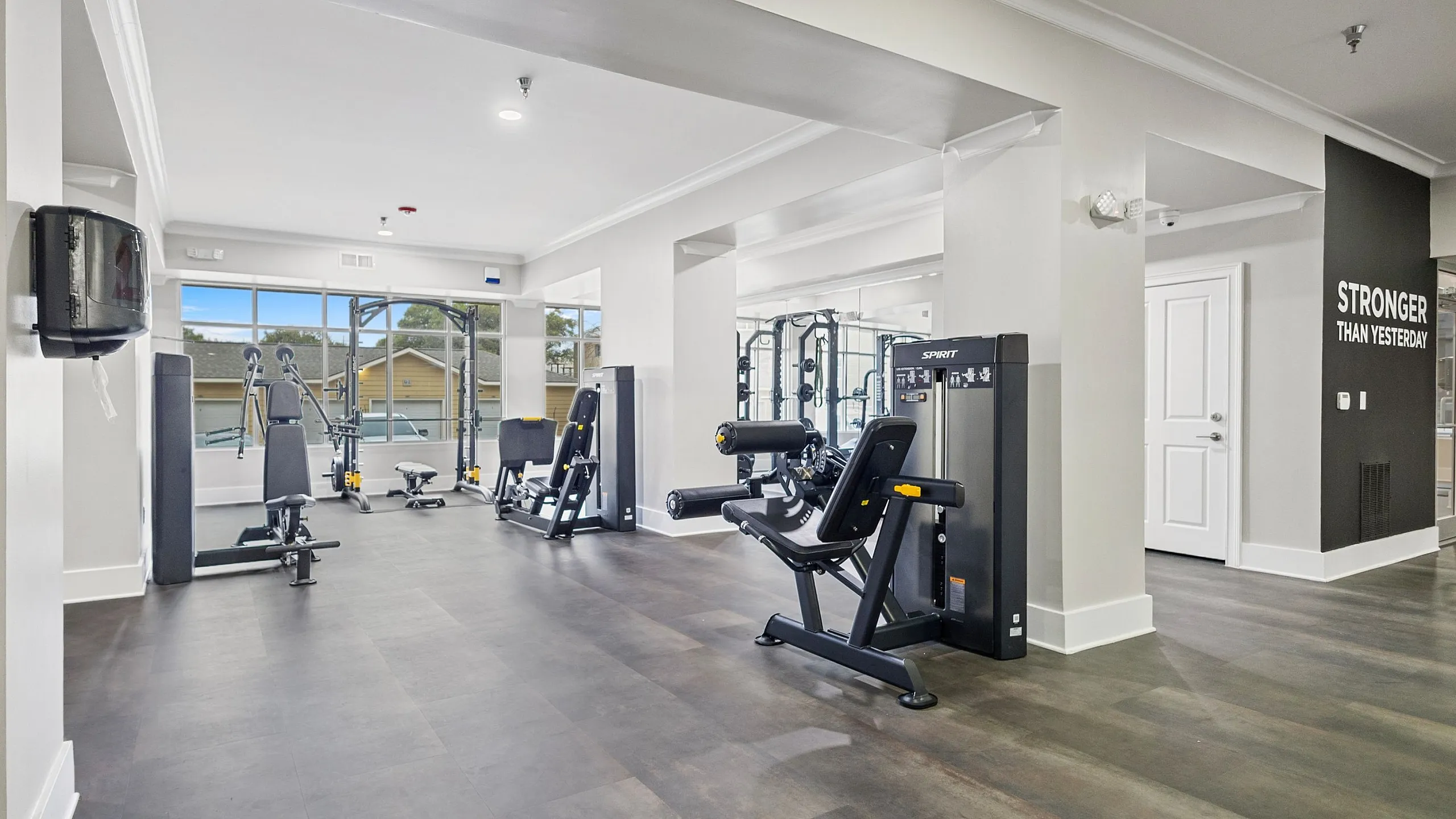 Modern fitness center with state-of-the-art gym equipment, sleek flooring, and motivational decor.