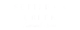Settler's Creek Apartment Homes sign with elegant lettering.