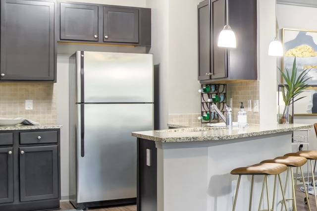 Chef Kitchen with Pendant Lighting and Designer Tile Backsplash