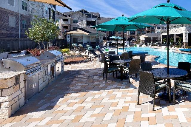 Poolside Community Grilling Area with Picnic Tables