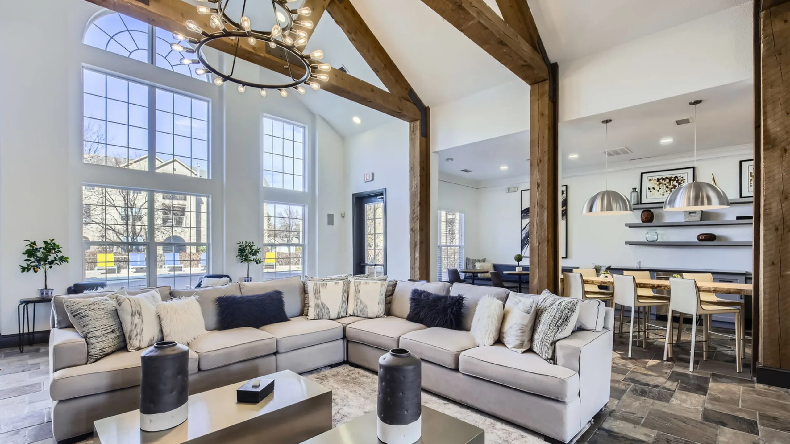 Experience the elegance of a modern clubhouse room with stunning high ceilings and abundant natural light.
