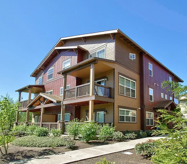 Picturesque suburban apartment building with stylish architecture and lush greenery.