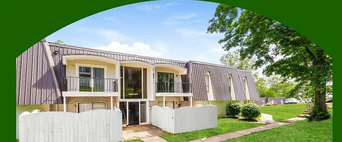 Charming apartment building with balconies and lush green surroundings, offering a harmonious blend of comfort and community living.