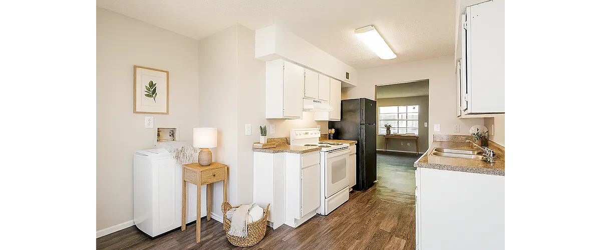 Bright and inviting kitchen with modern appliances, elegant cabinetry, and stylish wood flooring, perfect for culinary adventures.
